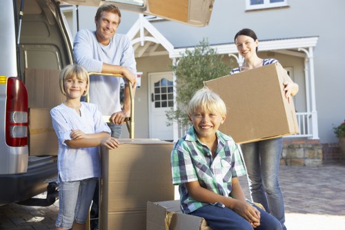 Professional house movers unloading items at an Abbey Wood property