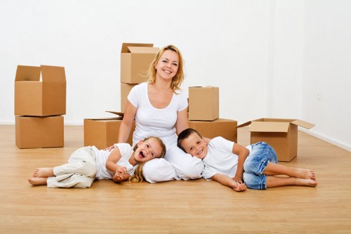 Office desks, chairs, and packed items prepared for relocation in Abbey Wood